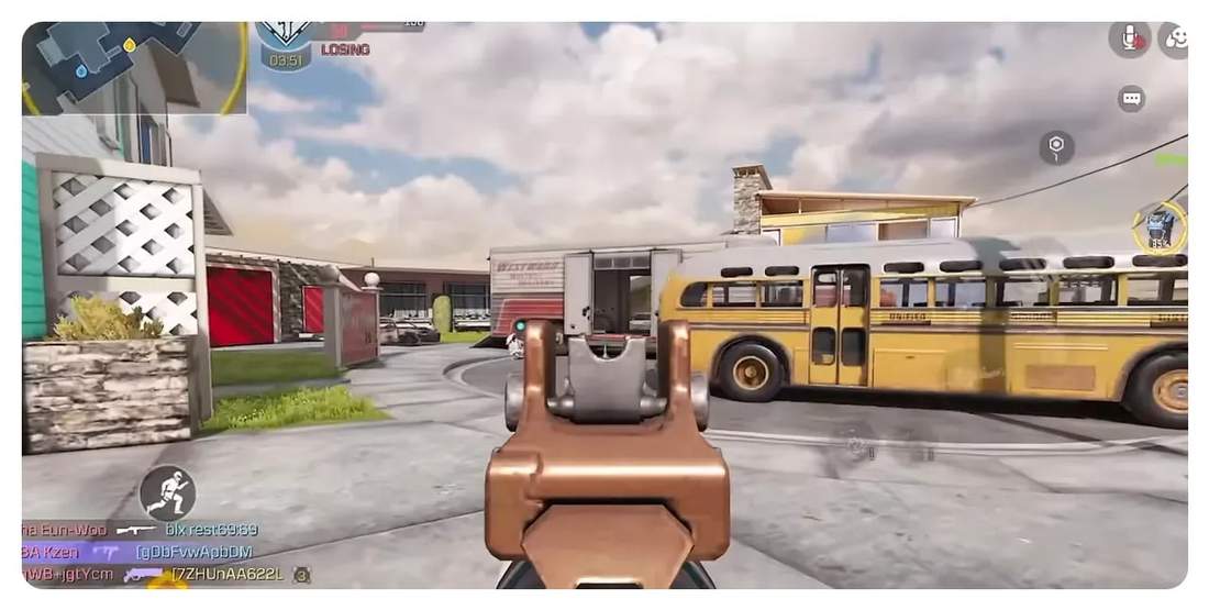 first-person iron-sight view down a street toward a bus demonstrating mid-range aim with AGR556