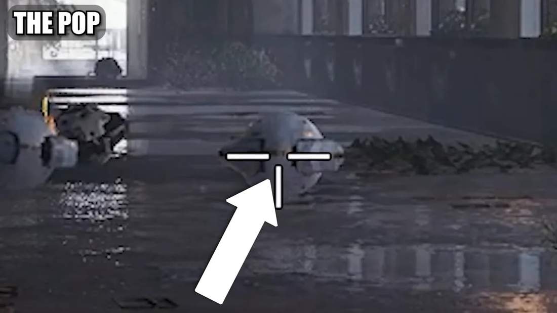 Zoomed-in crosshair arrow pointing at the Pop's round center showing the ideal aim point