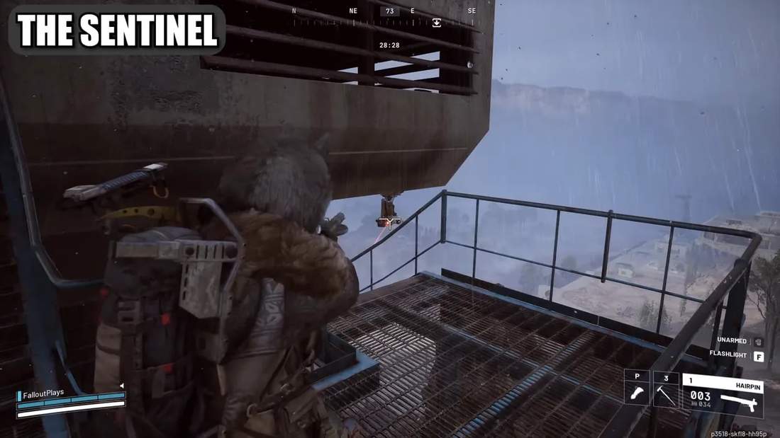 Player on a grated balcony aiming at a small Sentinel turret hanging under a platform in the rain, with the turret highlighted in the distance.