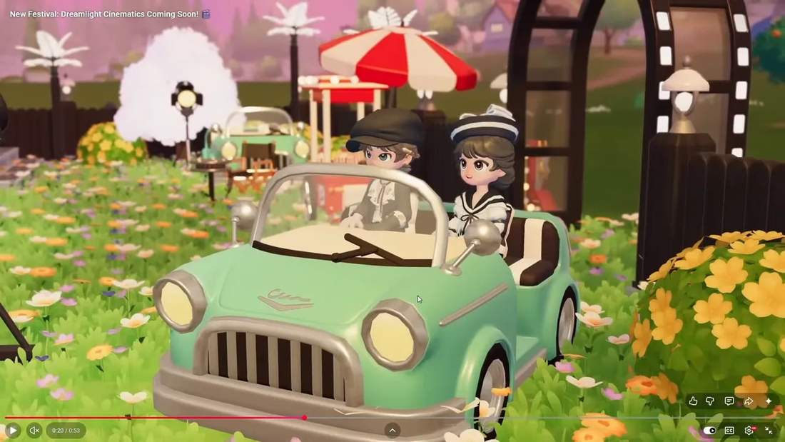 Drive-in cinema decor with a mint vintage car in front of a popcorn cart, film-reel arch and floral foreground.