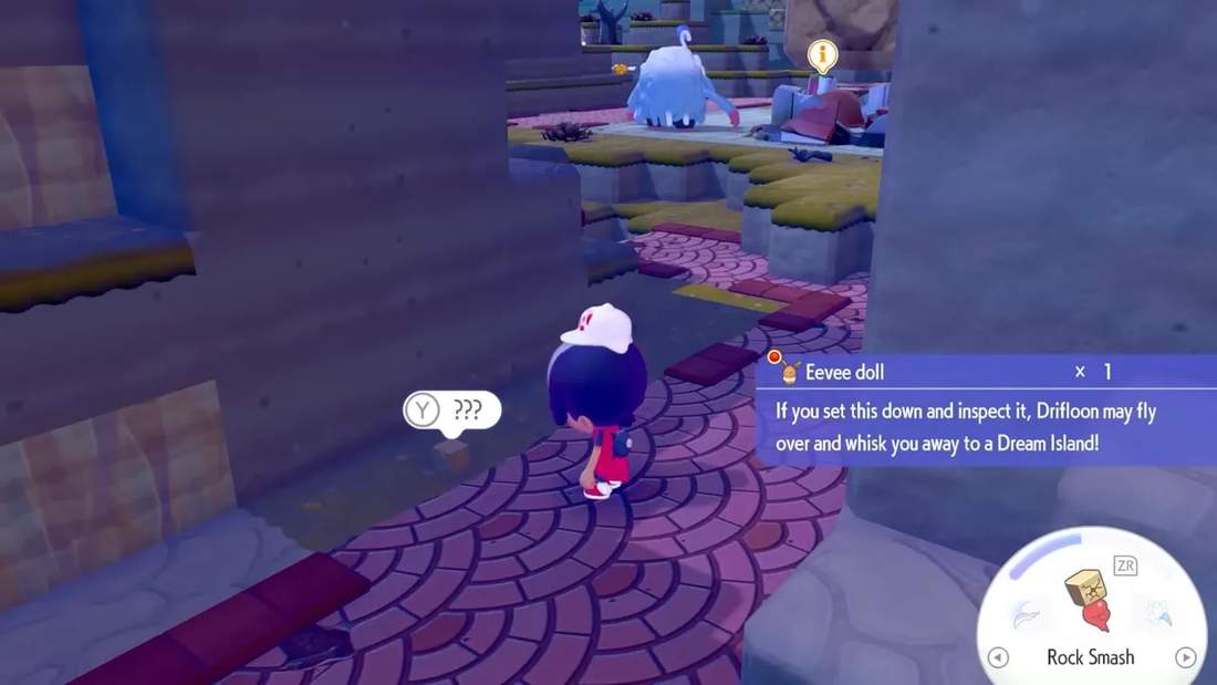 Eevee doll pickup notification in the UI reading 'If you set this down and inspect it, Drifloon may fly over and whisk you away to a Dream Island!'