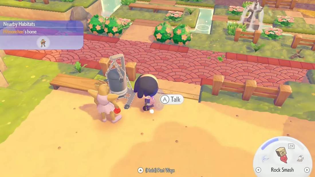 Hitmonchan standing by a punching bag with the 'Nearby Habitats' UI visible, ready to talk.