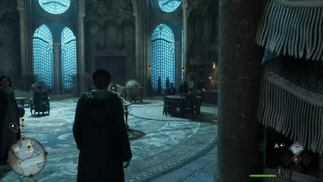 Player character standing inside a grand Hogwarts-style hall with tall windows and NPCs in Hogwarts Legacy