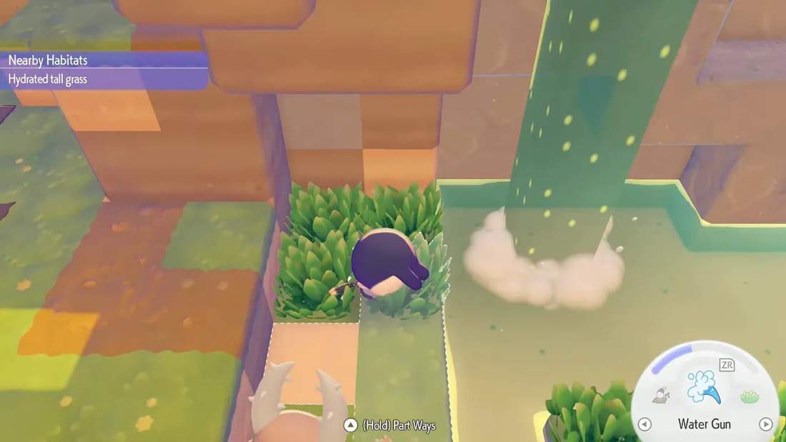 Top-down view of hydrated tall grass next to a small pond with the in-game 'Nearby Habitats: Hydrated tall grass' label