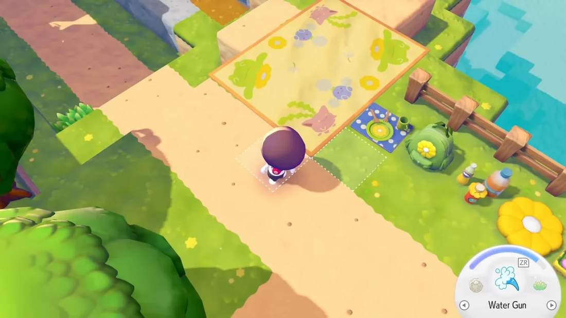 Crisp in-game shot showing the event picnic blanket with frog/flower designs, a backpack, table setting and flower cushion.