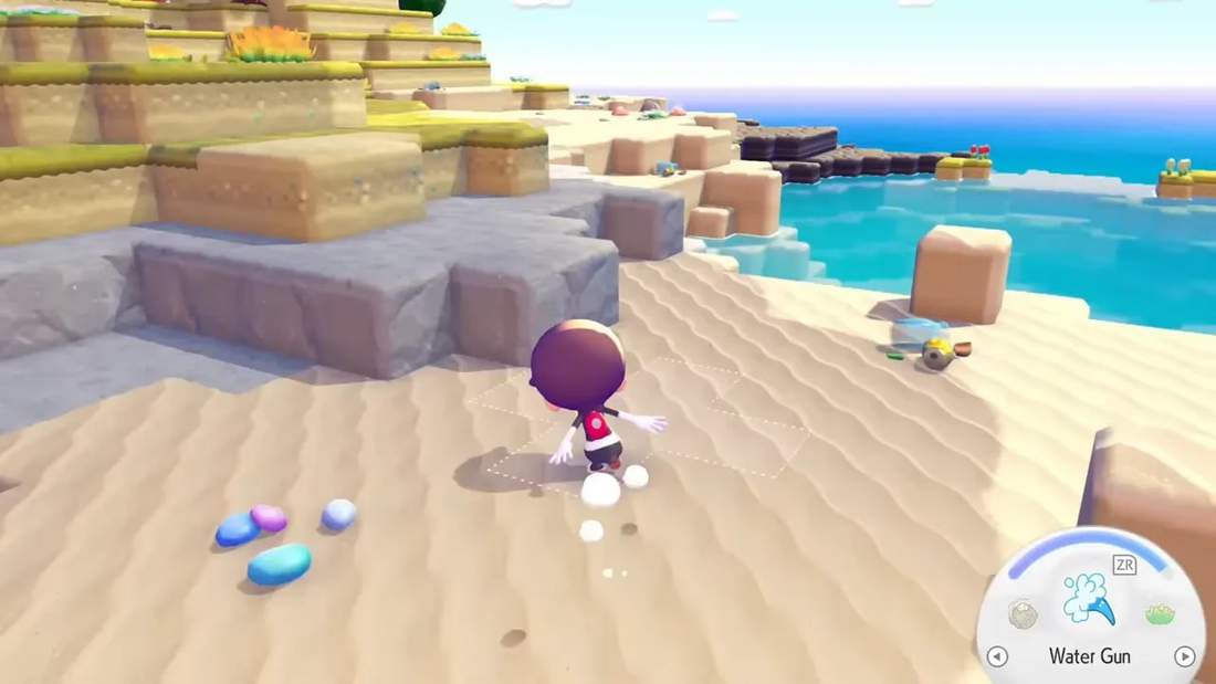 Player on an island shore with rocks and small shiny items scattered on sand