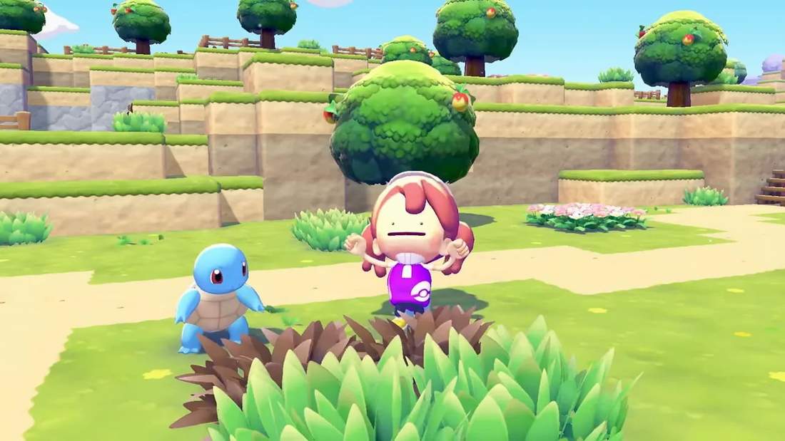 Player and Squirtle standing in a lush island area with trees and cliffs