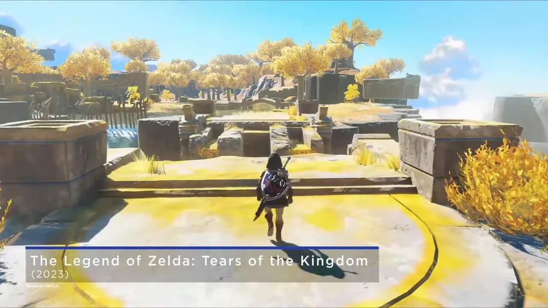 Third-person view of Link walking across ruins with wide draw distance and golden trees in The Legend of Zelda: Tears of the Kingdom.