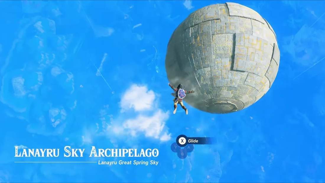 Link gliding toward a large floating spherical ruin in the Lanayru Sky Archipelago, Tears of the Kingdom