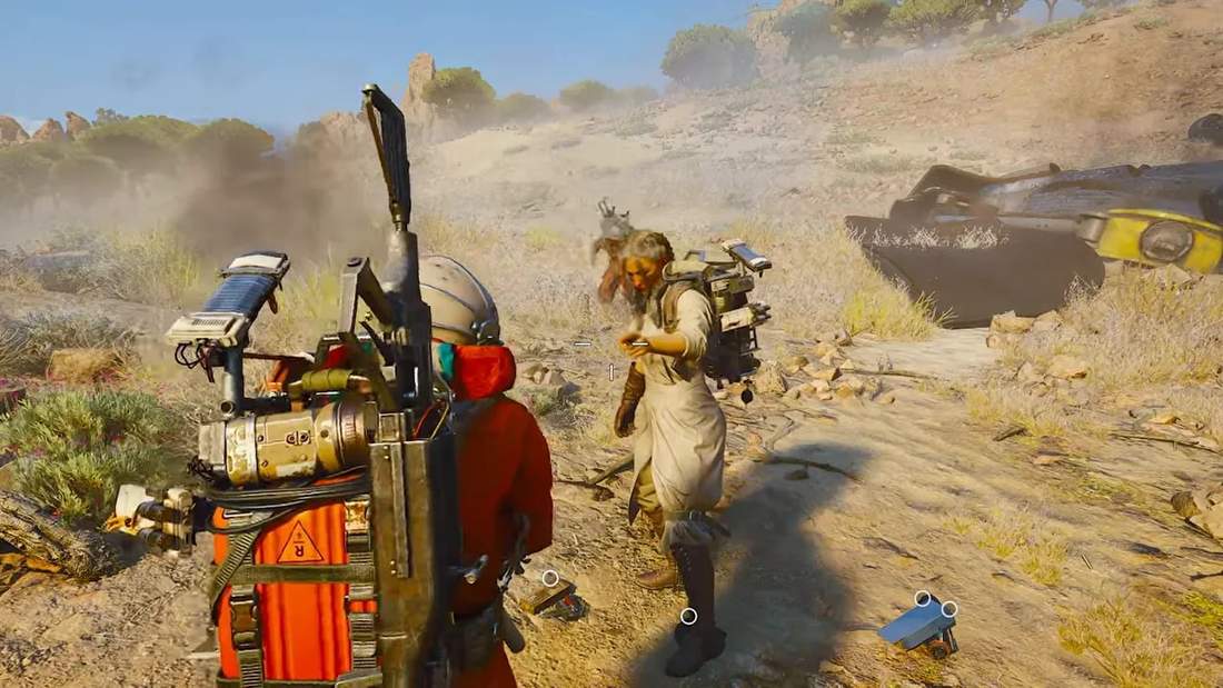 ARC Raiders characters standing in a desert loot area after a boss fight, surrounded by gear and smoke