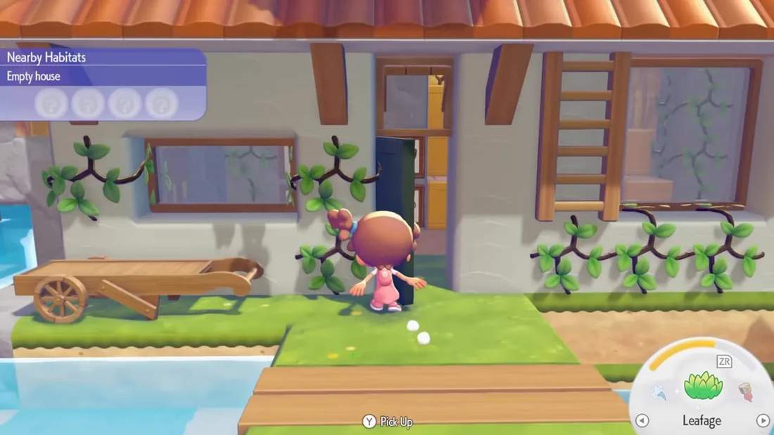 Pok&eacute;mon Pokopia interior storage wall with chests and labeled frames