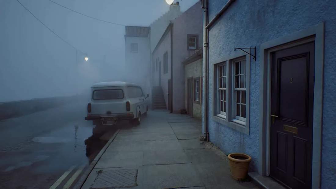 Foggy coastal street with blue buildings, a parked van and wet pavement