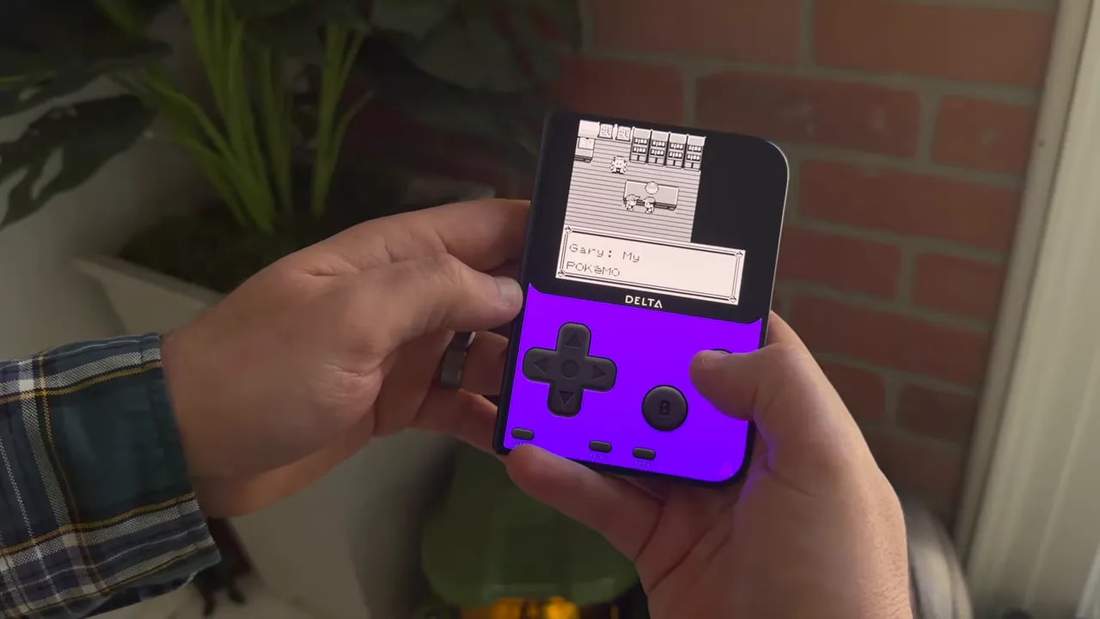 Folded phone displaying a monochrome Pok&eacute;mon game above purple touch controls