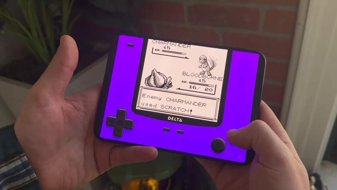 Unfolded phone displaying a Pok&eacute;mon battle with purple controls around the game image